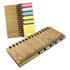 A bamboo sticky note holder with yellow, pink, and blue sticky notes and a ruler along one edge. It features a spiral binding.