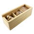 A wooden box containing various puzzle pieces, including spheres and shapes, in a natural wood finish.