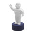 A stress toy featuring a white, cartoonish figure with arms raised, standing on a navy blue base.
