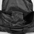 A black duffle bag interior with a zipped pocket and spacious main compartment. It features a logo.