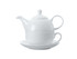 A white tea pot with a cup and saucer, elegantly stacked, made of porcelain for tea servings.