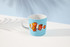 A coffee mug featuring a colourful fish design on a blue background, with a handle and inner white colour.