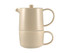 A beige tea set comprising a teapot and cup that stack neatly together, featuring a simple, modern design.