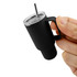 A drink tumbler in matte black with a handle, clear lid, and stainless steel straw, designed for insulation.