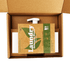 A cardboard box containing laundry detergent sheets and a dispensing bottle, featuring green and brown packaging.