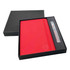 A red A5 notebook and a pen, both presented in a black gift box. The notebook features a logo.