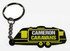 A black and yellow PVC keyring shaped like a caravan, featuring a logo.
