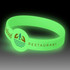 A glow-in-the-dark silicone wristband in green, featuring a logo and decorative elements.