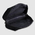 A black toiletry bag with a zippered opening, featuring multiple compartments and a patterned interior.