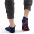 Low cut gripper socks in navy blue with a non-slip pattern on the sole, worn with grey joggers.