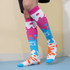Knee-high socks featuring a vibrant pink, blue, and orange splash pattern with a logo.