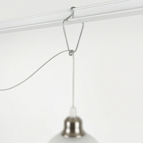 Silver metal sign clip attached to a ceiling rail and suspending a light fixture cable.