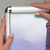 Hand demonstrating poster inside silver  metal wall-mounted snap frame with clear anti-glare cover for retail and business sign displays, Item# CSF1-2228