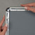 Hand opening poster inside silver metal  wall-mounted snap frame with clear anti-glare cover for retail and business sign displays, Item# CSF1-2436