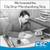 Archival black-and-white Clip Strip photo of a man writing at a desk.