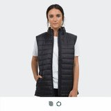 A woman is wearing a black puffer vest with a high collar, featuring side pockets and a sleek design.