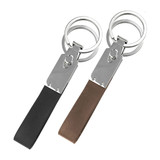 A pair of multi key rings featuring shiny silver metal and sleek black and brown leather straps.