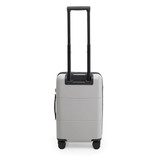 A silver carry-on suitcase with a retractable handle and wheels, featuring a simple design and a logo.