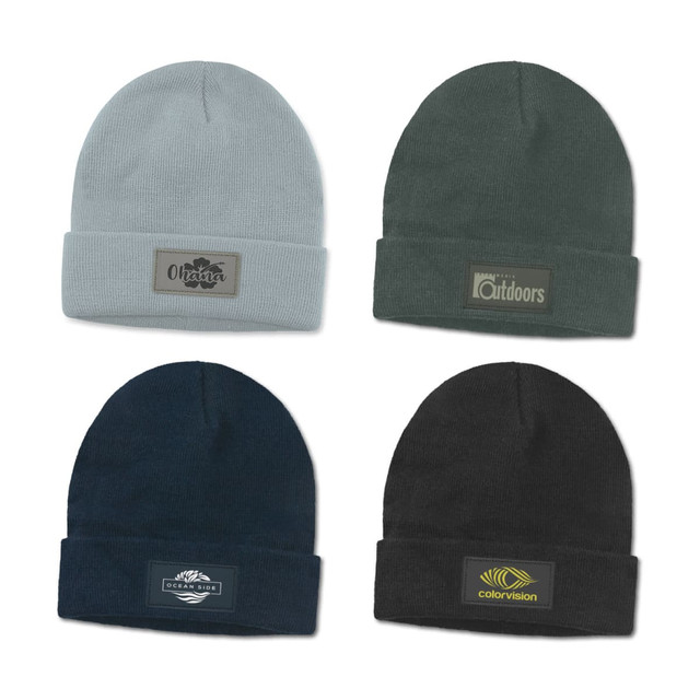 A collection of four beanies in grey, dark green, navy, and black, each featuring a different patch or logo.