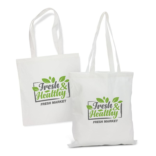 A white tote bag with green leaf designs and a logo. It features two sturdy handles for carrying.