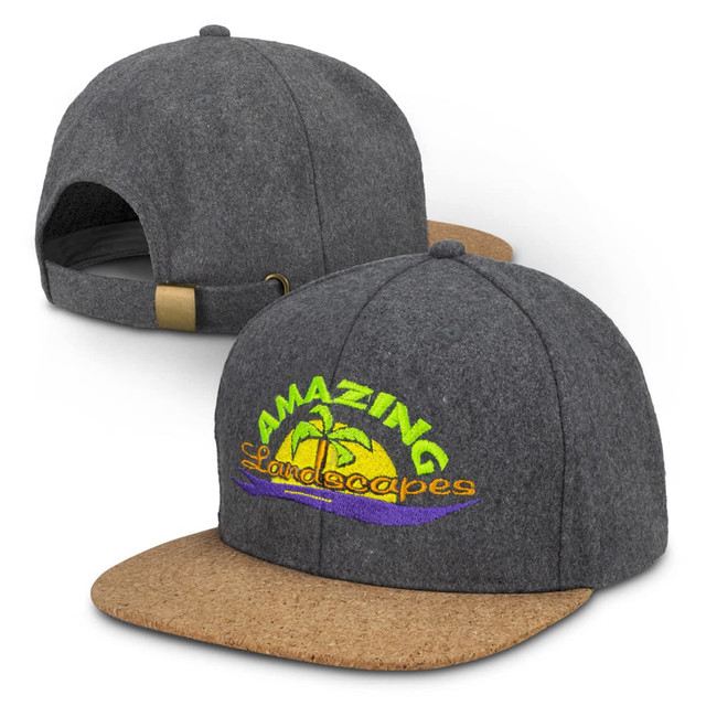 A grey cap with a cork peak and an embroidered logo featuring colourful text and a palm tree design.