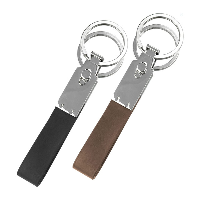 A pair of multi key rings featuring shiny silver metal and sleek black and brown leather straps.