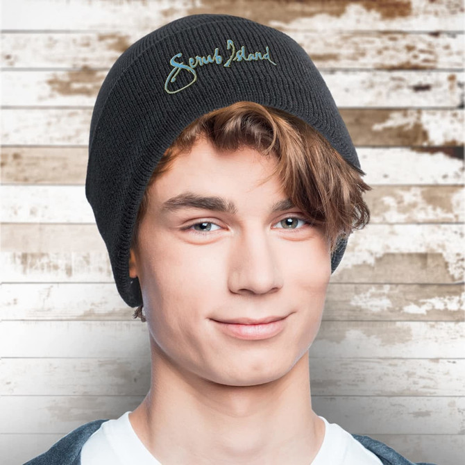 A dark grey beanie sits snugly on a young man's head, featuring a logo on the front.