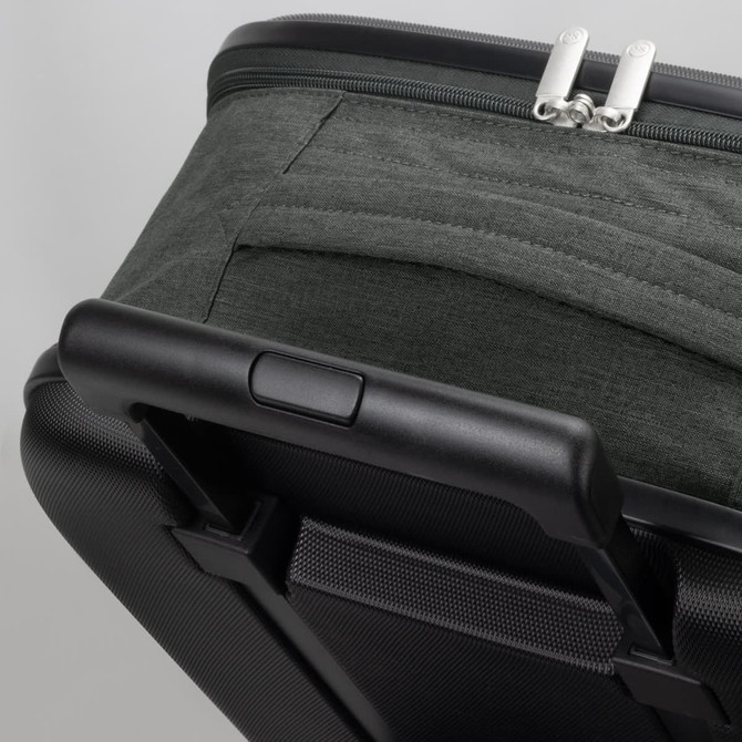 A small wheeled suitcase in dark green fabric with a black hard shell and a retractable handle.