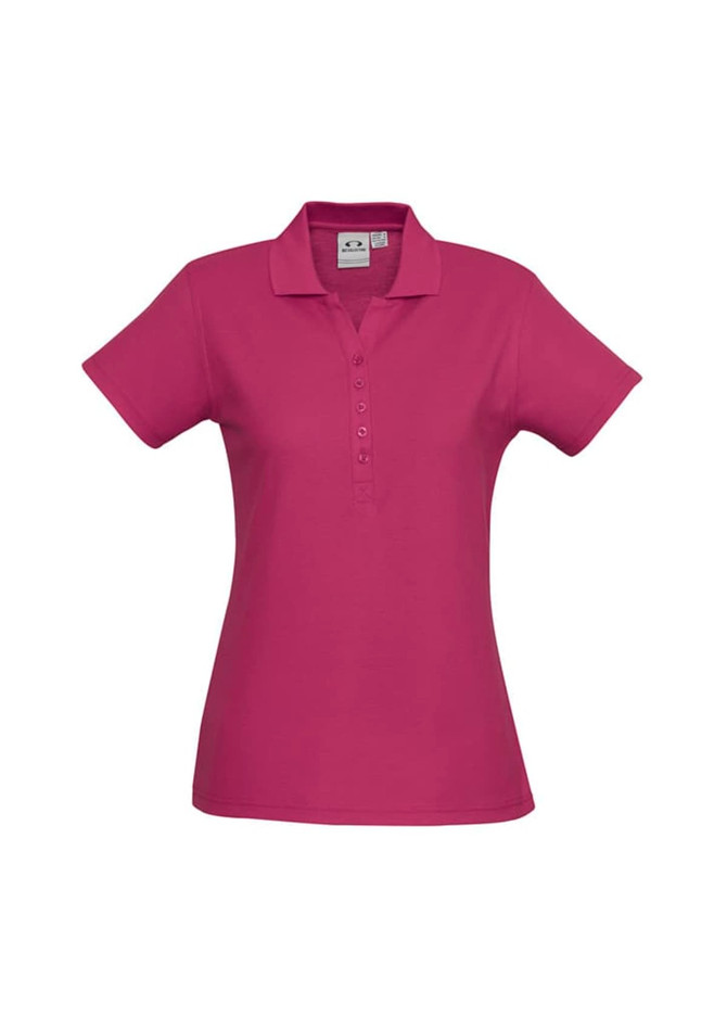A magenta ladies polo shirt featuring a collared neck and button placket, with a logo on the label.