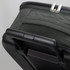 A small wheeled suitcase in dark green fabric with a black hard shell and a retractable handle.