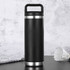 A drink bottle in matte black with a stainless steel base and a handle, featuring a simple design.