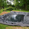 DIY pond liner installation in progress