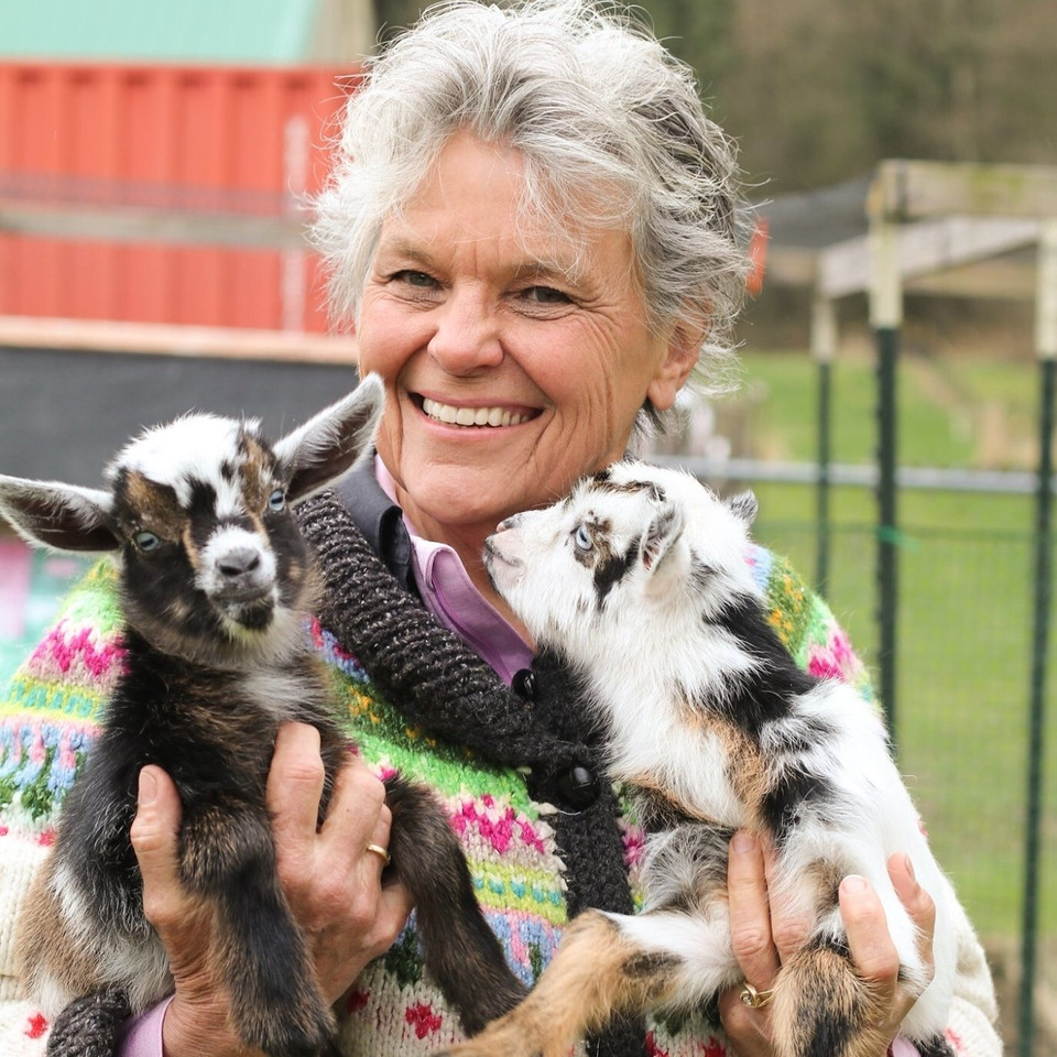 Grace Lukens holding baby goats at Grace Harbor Farms in Washington
