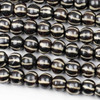 Cherry Tree Beads 10x12mm black bone rondelle beads with carved white vertical line patterns, 8-inch strand.