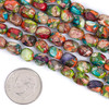 Cherry Tree Beads Dyed Fiesta Rainbow Impression Jasper 5x7mm Drum Beads shown next to a coin for size reference on a 15-inch strand.