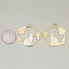 Enameled gold pewter 30mm circular cat charm with floral details shown next to a coin for size reference