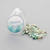 Cherry Tree Beads Ocean Haze Crystal Bead Designer Collection displayed beside its storage jar, ready for DIY jewelry making.