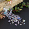 bead collection with rich purples, soft lavender tones, and shimmering iridescent finishes