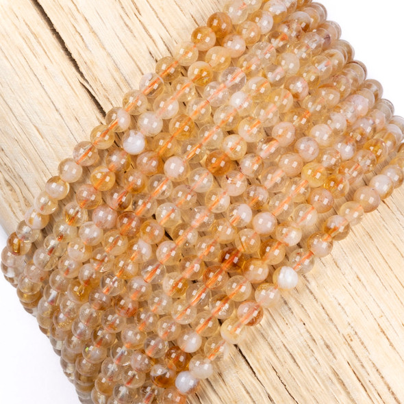Cherry Tree Beads Citrine 4mm Round Beads on a 15-inch strand featuring natural golden-yellow gemstone beads with a smooth polished finish for jewelry making.