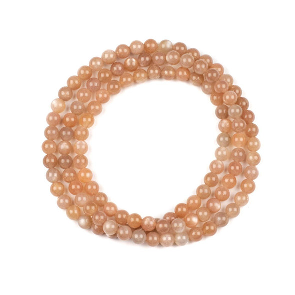Peach Moonstone 6mm Mala Round Beads - 115 beads per strand, featuring smooth, polished natural gemstone beads in soft peach tones, perfect for mala making and jewelry crafting.