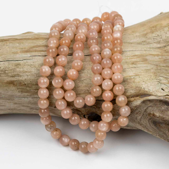 Peach Moonstone 6mm Mala Round Beads - 115 beads per strand, showcasing natural gemstone beads in soft peach hues with a polished finish, ideal for mala and jewelry crafting.