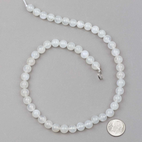 Blue Moonstone 8mm round beads in a 15-inch strand, highlighting the ethereal shimmer and natural beauty of gemstone beads with a size reference for scale.