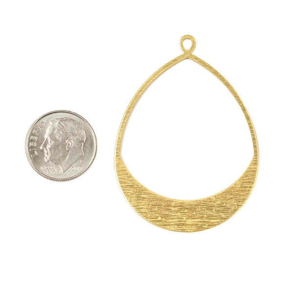One large textured teardrop hoop component, available in raw and coated brass finishes, displayed flat to show the hammered detail and elegant shape.