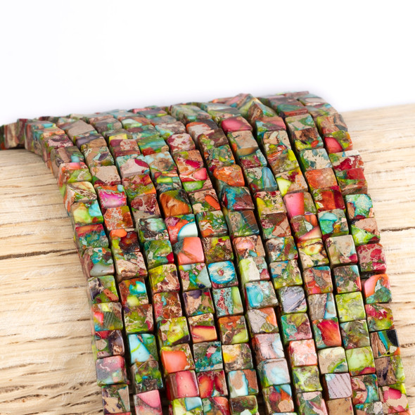 Cherry Tree Beads Dyed Fiesta Rainbow Impression Jasper 4mm Cube Beads - color #06 on a 15-inch strand featuring colorful gemstone cube beads for jewelry making.
