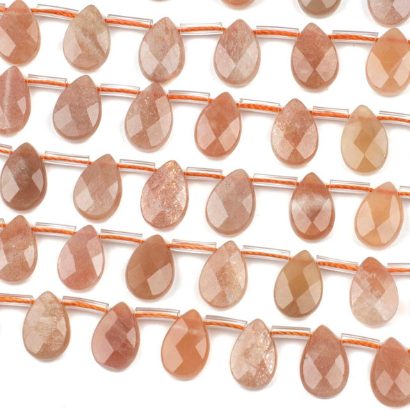 Peach Moonstone 8x12mm top drilled faceted flat teardrop beads in natural peach tones, shown in a 15 inch strand with 32 polished gemstone beads.