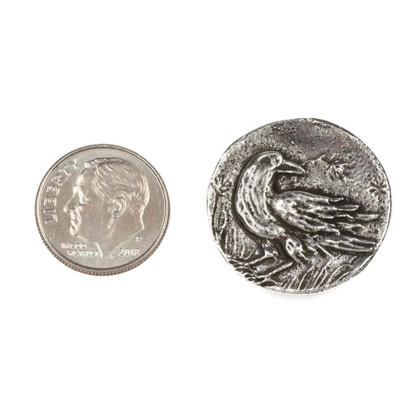 Green Girl Studios pewter approx. 23mm Raven Button, shown next to a dime for size reference, featuring a detailed raven design, crafted from pewter for jewelry making and decorative accents.
