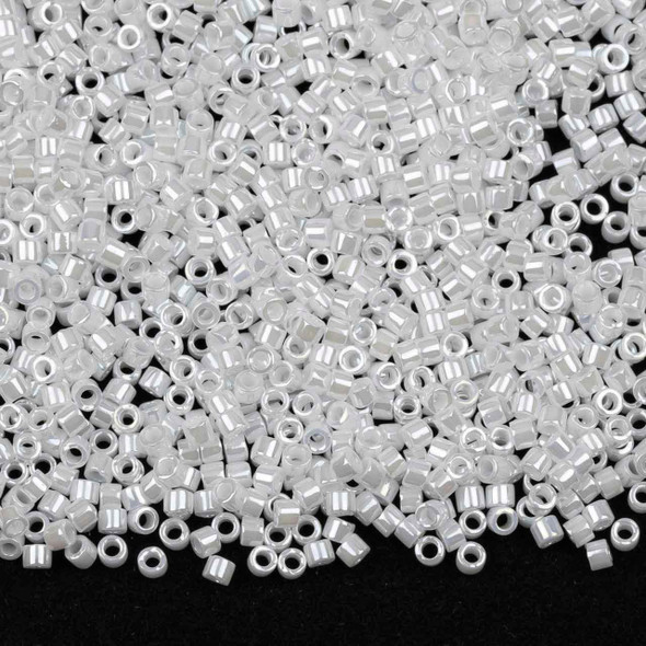 A 6.8-gram tube of Miyuki 11/0 White Pearl Delica seed beads (#DB201), featuring precision-cut glass seed beads with a smooth pearlescent finish, ideal for bead weaving and intricate jewelry designs.