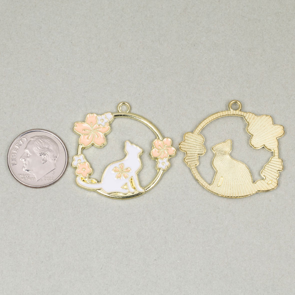Enameled gold pewter 30mm circular cat charm with floral details shown next to a coin for size reference
