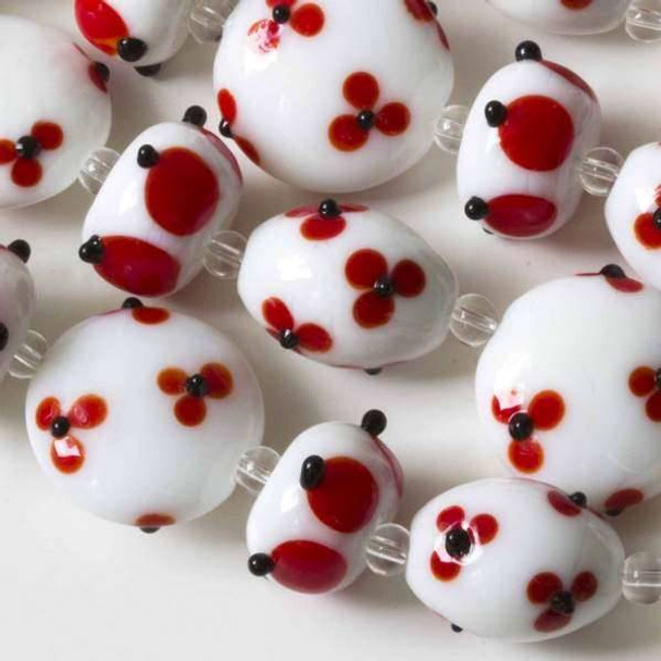 Handmade Lampwork Glass alternating White 13x18mm Eggs, 14mm Rondelles, and 20mm Coins with Red Flowers and Black Bumpy Dots - approx. 4 inch strand