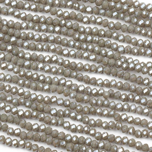Crystal beads in approximately 2x2mm opaque mink gray faceted rondelle shape, arranged on a 15-inch circular strand.